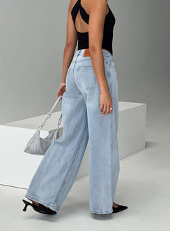 back view of model wearing Princess Polly Ramos Low Rise Denim Jeans Light Wash Petite Low Rise Jeans 