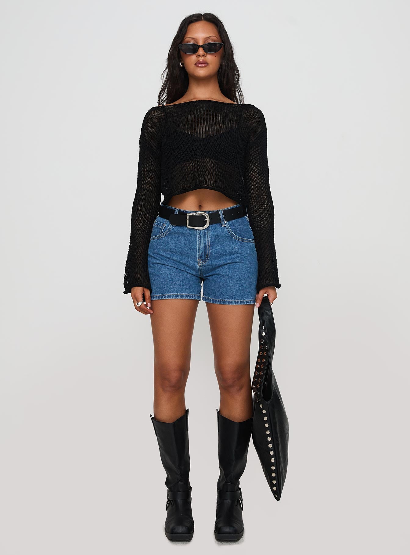 side view of model wearing Princess Polly Saldana Shorts Mid Blue Denim High Waisted Shorts 