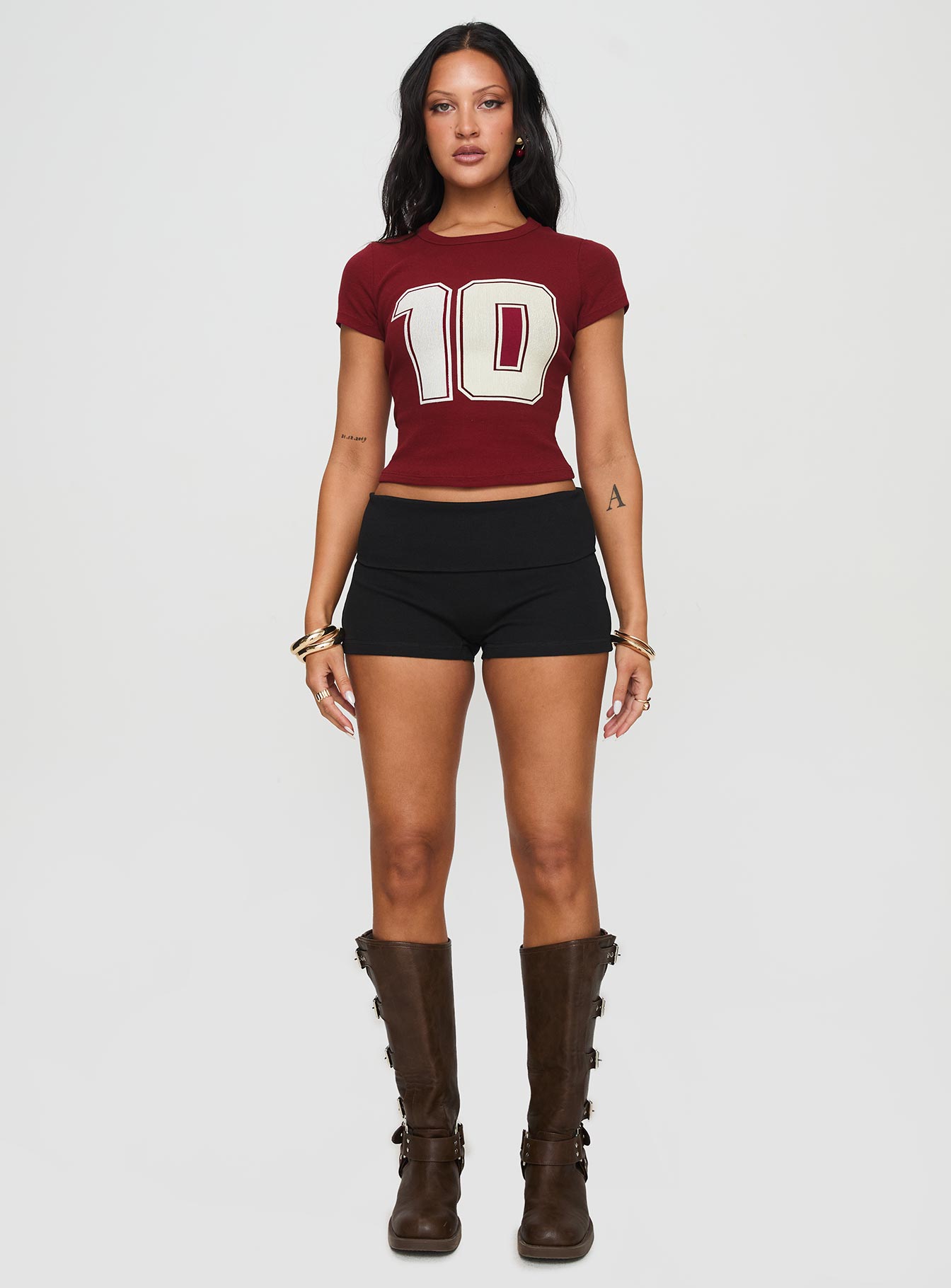 side view of model wearing Princess Polly Baseline Low Rise Rib Shorts Black High Waisted Shorts 