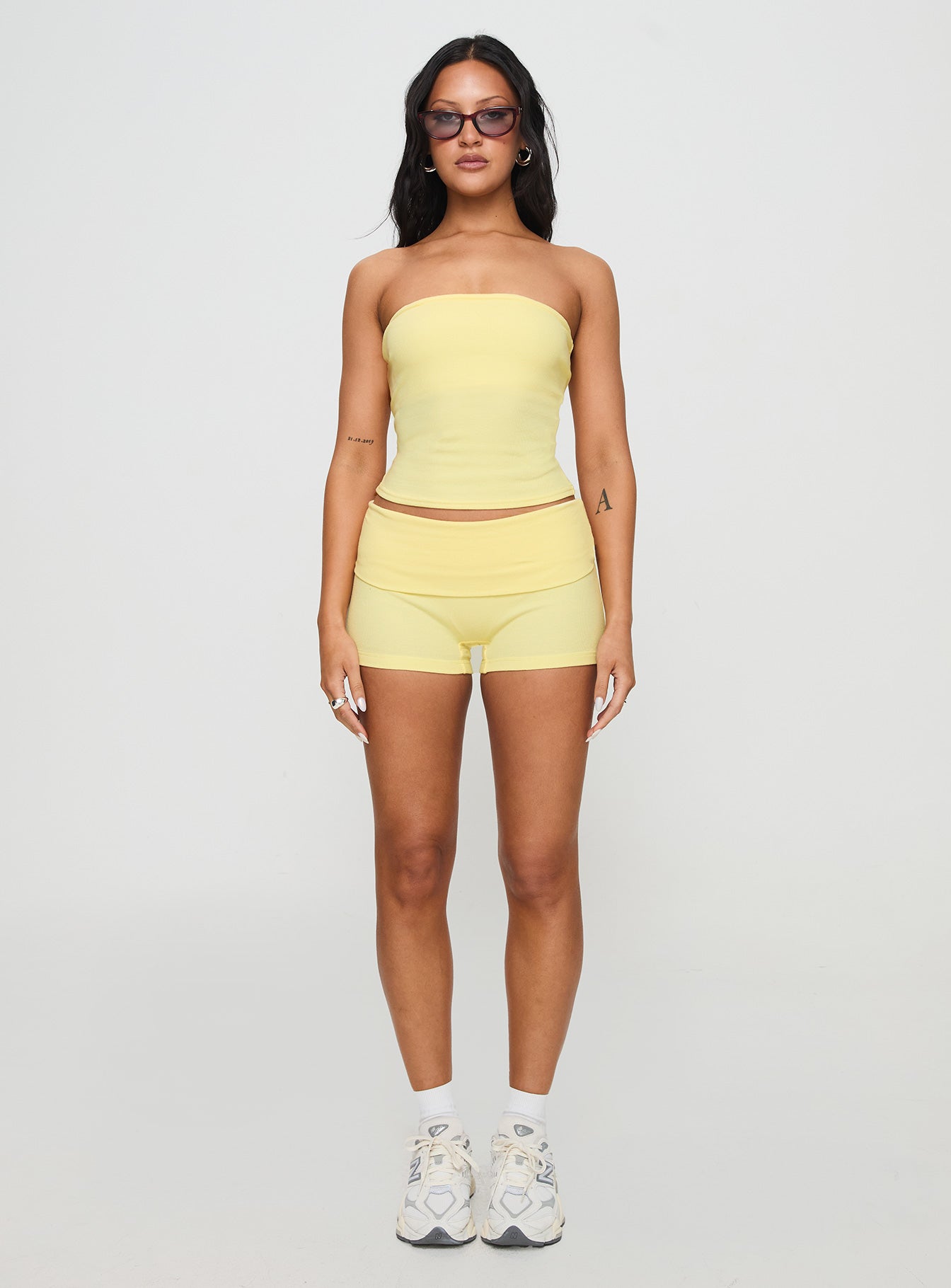 side view of model wearing Princess Polly Baseline Low Rise Rib Shorts Yellow Low Rise Shorts 