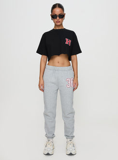 side view of model wearing Princess Polly Harvard Graphic Track Top Black Short Sleeves Crew Neck 