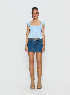   front view of model wearing Princess Polly Warna Low Rise Denim Mini Skirt Mid Blue Wash Mini Skirts 