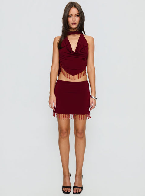   side view of model wearing Princess Polly Ginah Bead Tassel Mini Skirt Red Mini Skirts 
