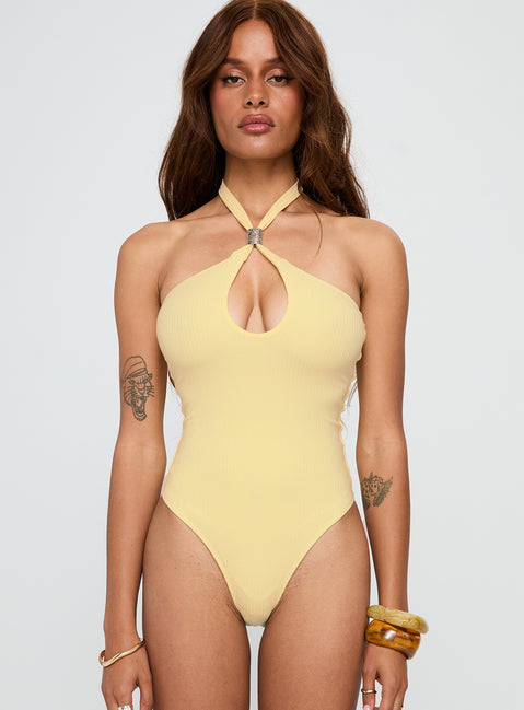 Showcasing the Dulce Vita Hardware Detail Bodysuit Lemon in womens-bodysuit with sleeveless design front view of model wearing Princess Polly