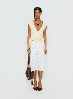 side view of model wearing Princess Polly Roda Anglaise Longline Shorts White Mid Rise Pants 