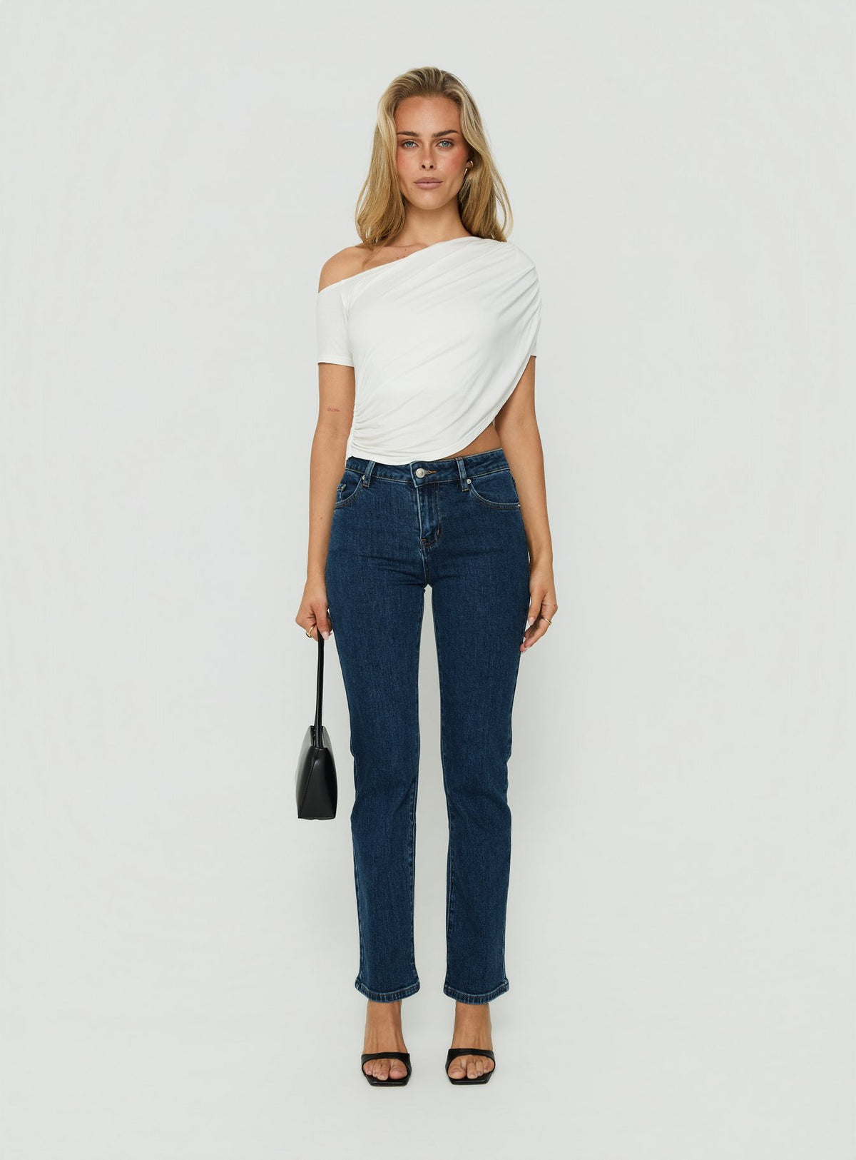 Presenting the Harpor Mid Rise Slim Skinny Jean Mid Blue Wash womens-jeans with belt on-body view of model wearing Princess Polly