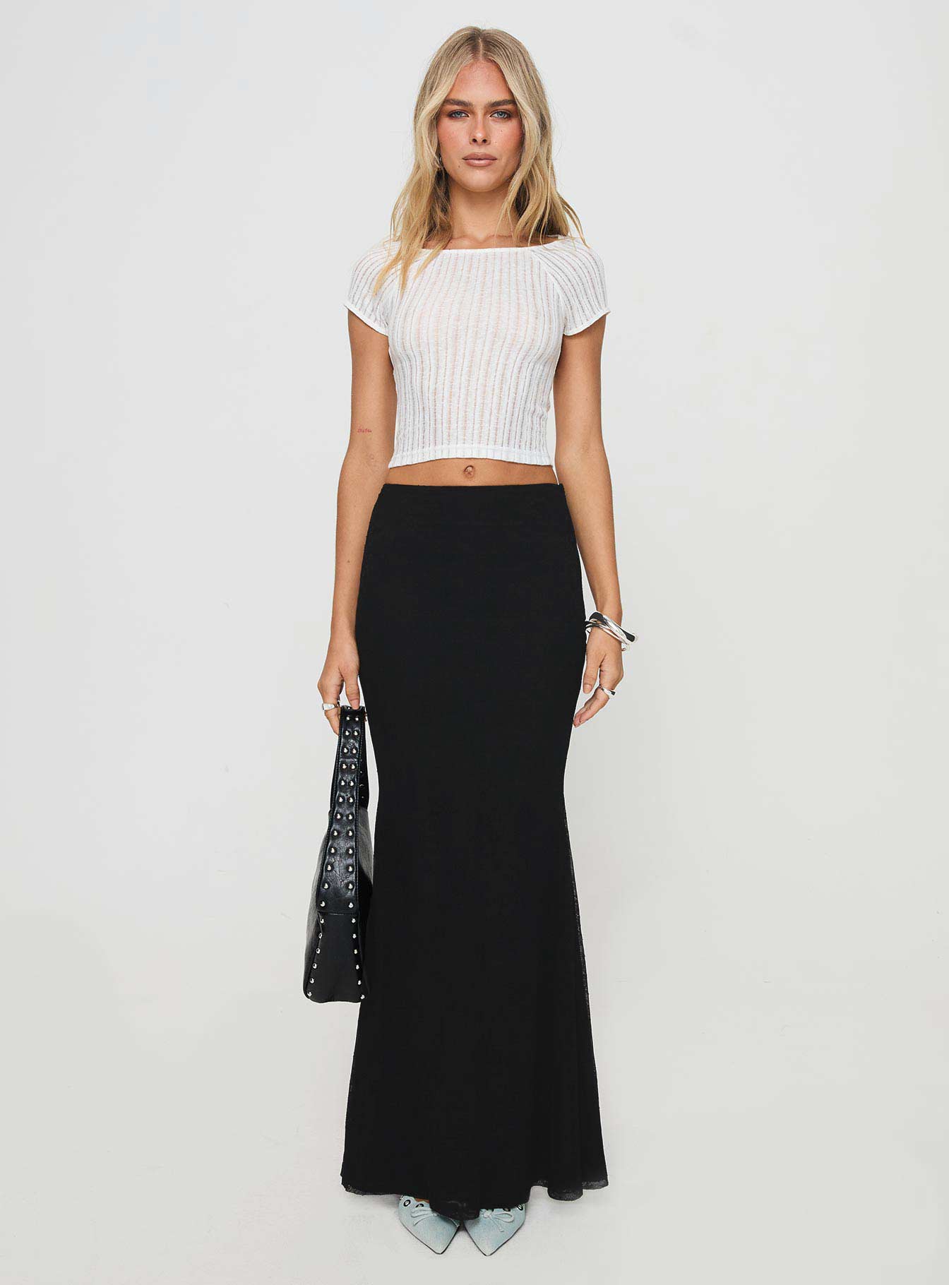   side view of model wearing Princess Polly Topping Maxi Skirt Black Maxi 