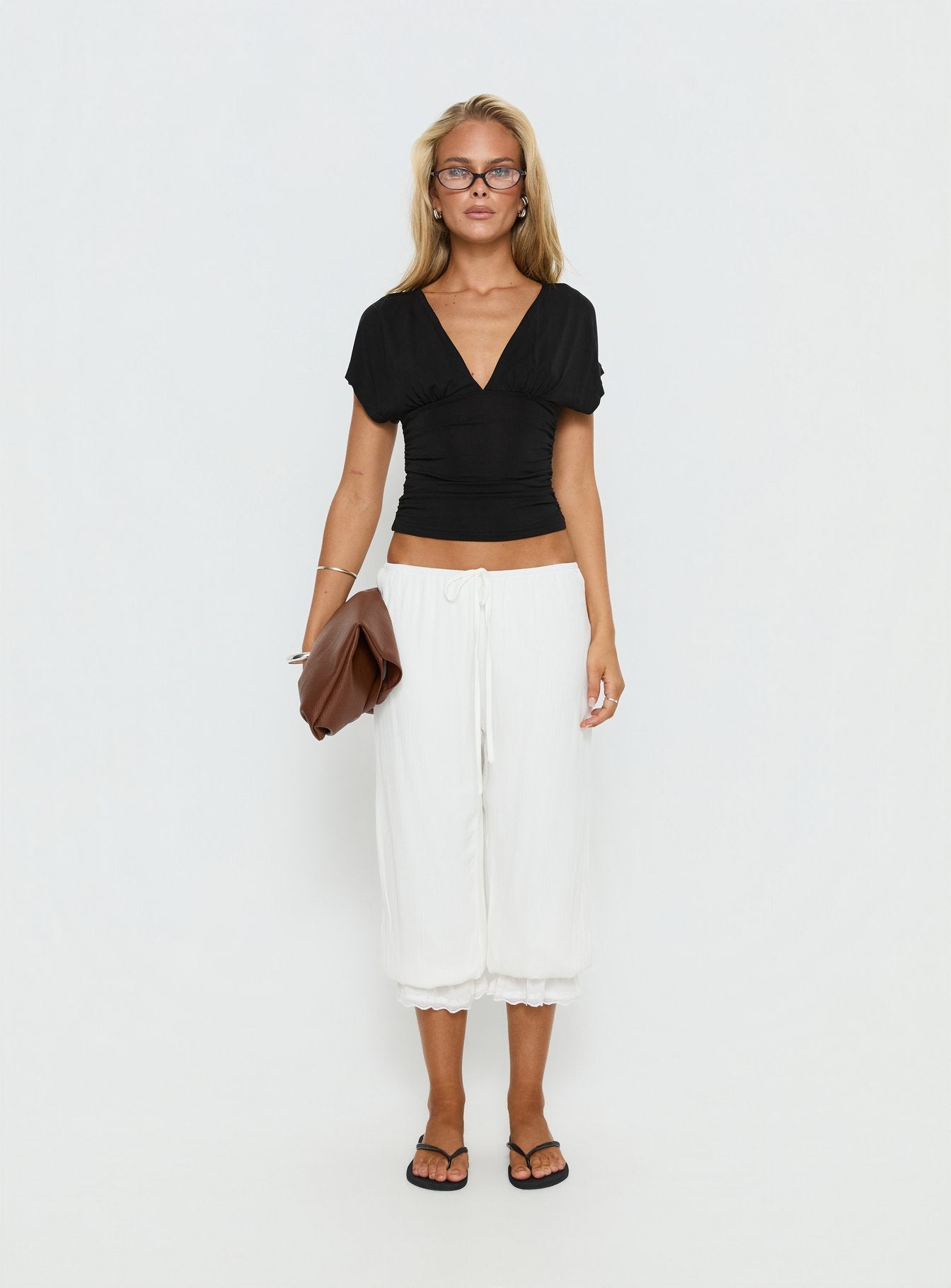 side view of model wearing Princess Polly Basma Bloomer Trouser Pants Rayon White Mid Rise Pants 