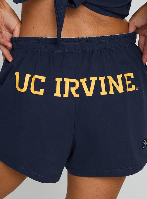side view of model wearing Princess Polly UC Irvine Soffee Shorts Blue High Waisted Shorts 