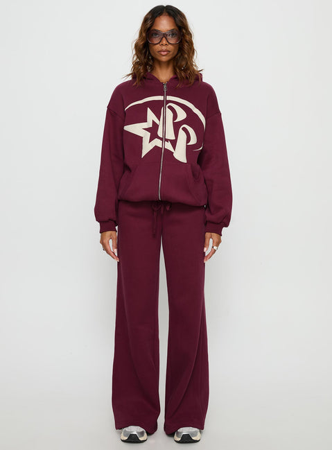Showcasing the Stargirl Zip Through Jumper in burgundy womens jumpers with long oversized fit, graphic print and hood details front view of model wearing Princess Polly