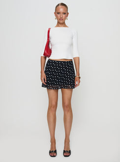   side view of model wearing Princess Polly Dapple Bias Mini Skirt Black Polka Dot Mini Skirts Skirts 