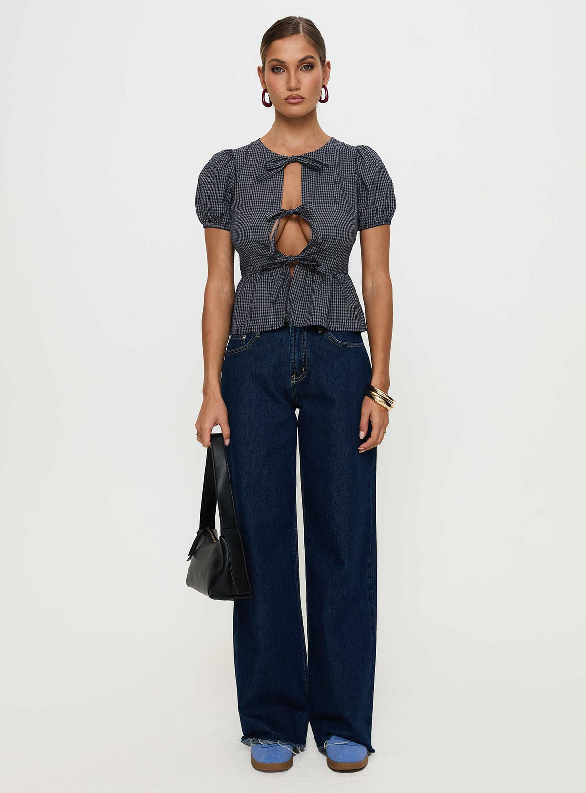 side view of model wearing Princess Polly Verah Tie Up Puff Sleeve Top Navy Check Short Sleeves Scoop Neck 