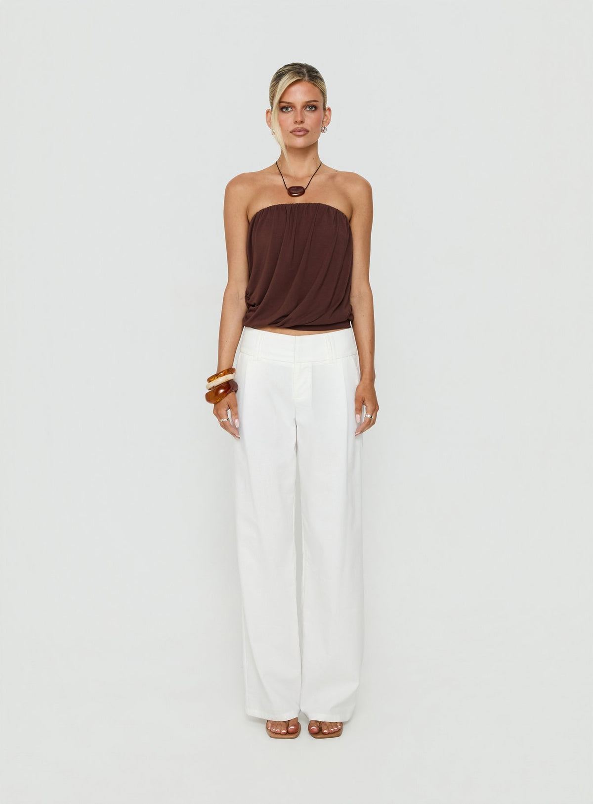 Showcasing the Two Lovers Linen Low Rise Pants White in womens regular pants, featuring low-rise waistband and wide-leg silhouette, front view of model wearing