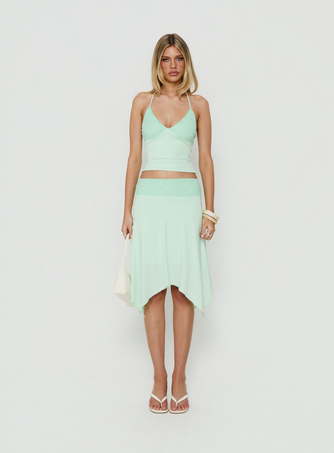 Showcasing the Natabelle Lace Detail Midi Skirt in Mint, a womens-skirts piece with asymmetry and fitted fit Princess Polly