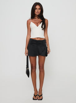 back view of model wearing Princess Polly Farfalle Mini Skirt Black Mini Skirts Skirts 
