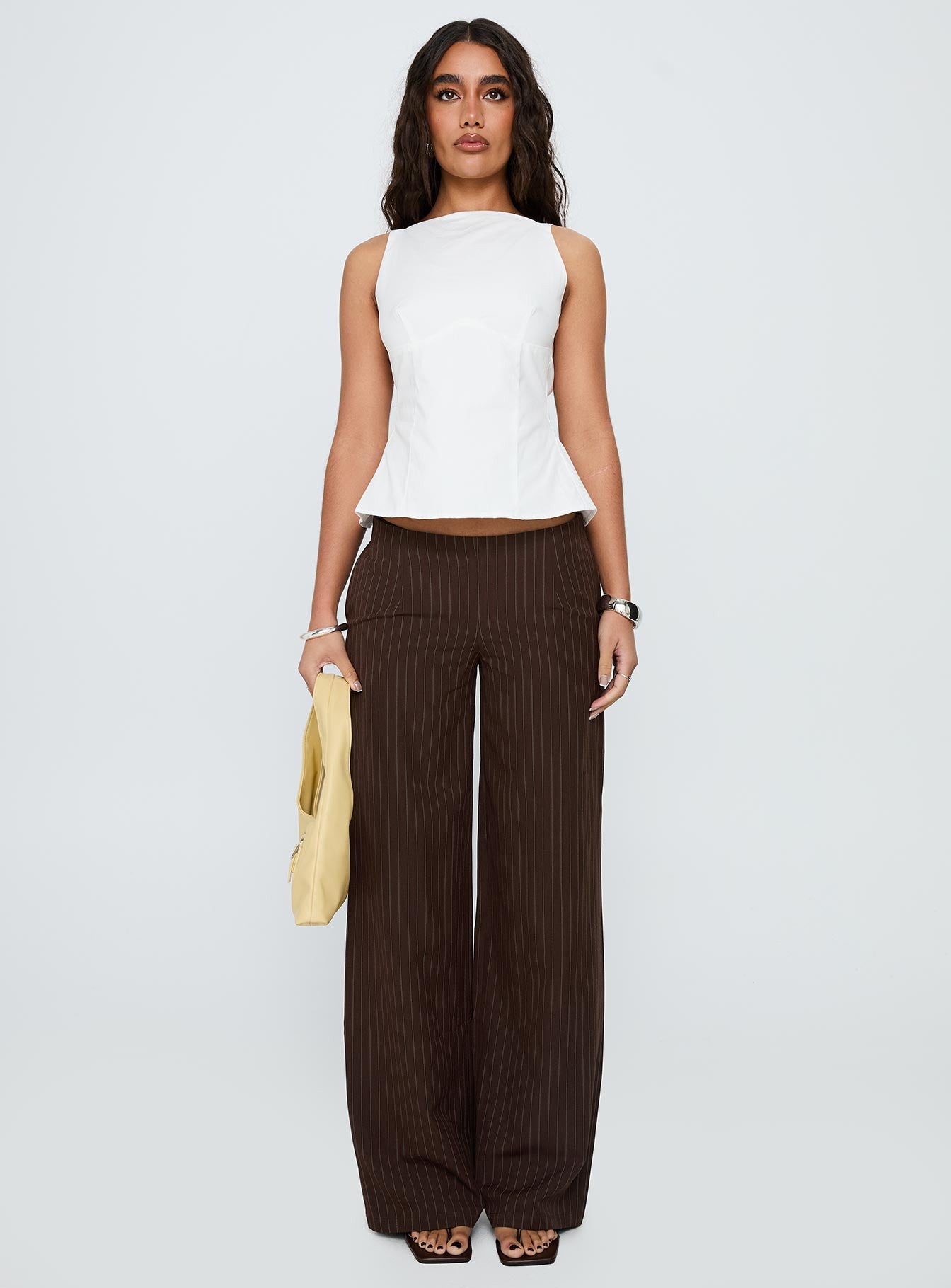 front view of model wearing Princess Polly Khane Low Rise Wide Leg Pant Brown Pinstripe Low Rise Pants 