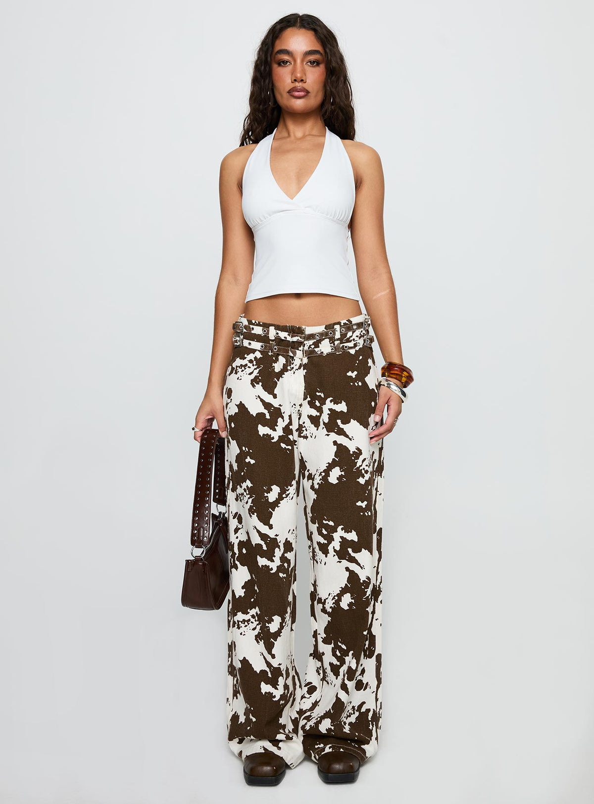 side view of model wearing Princess Polly Baccarat Belted Pant Cow Print Low Rise Jeans 