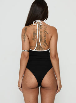 Designed with a sleeveless cut, the Azara Contrast Arrowneck Bodysuit Black / White womens-bodysuit back view of model wearing Princess Polly