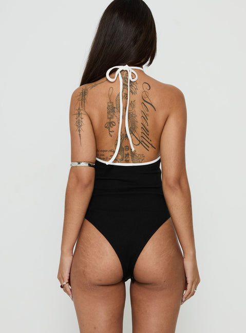 Designed with a sleeveless cut, the Azara Contrast Arrowneck Bodysuit Black / White womens-bodysuit back view of model wearing Princess Polly