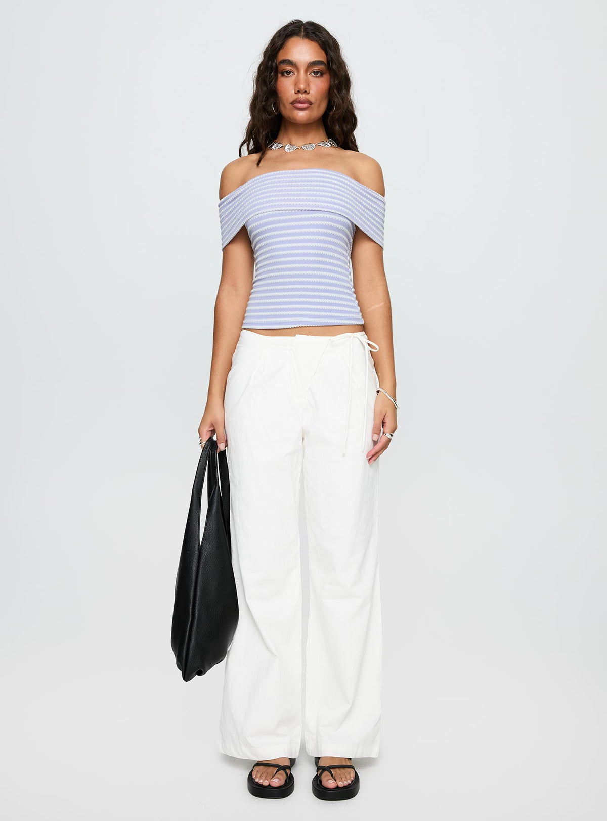 side view of model wearing Princess Polly Leyah Tie Side Pants White Low Rise Pants 