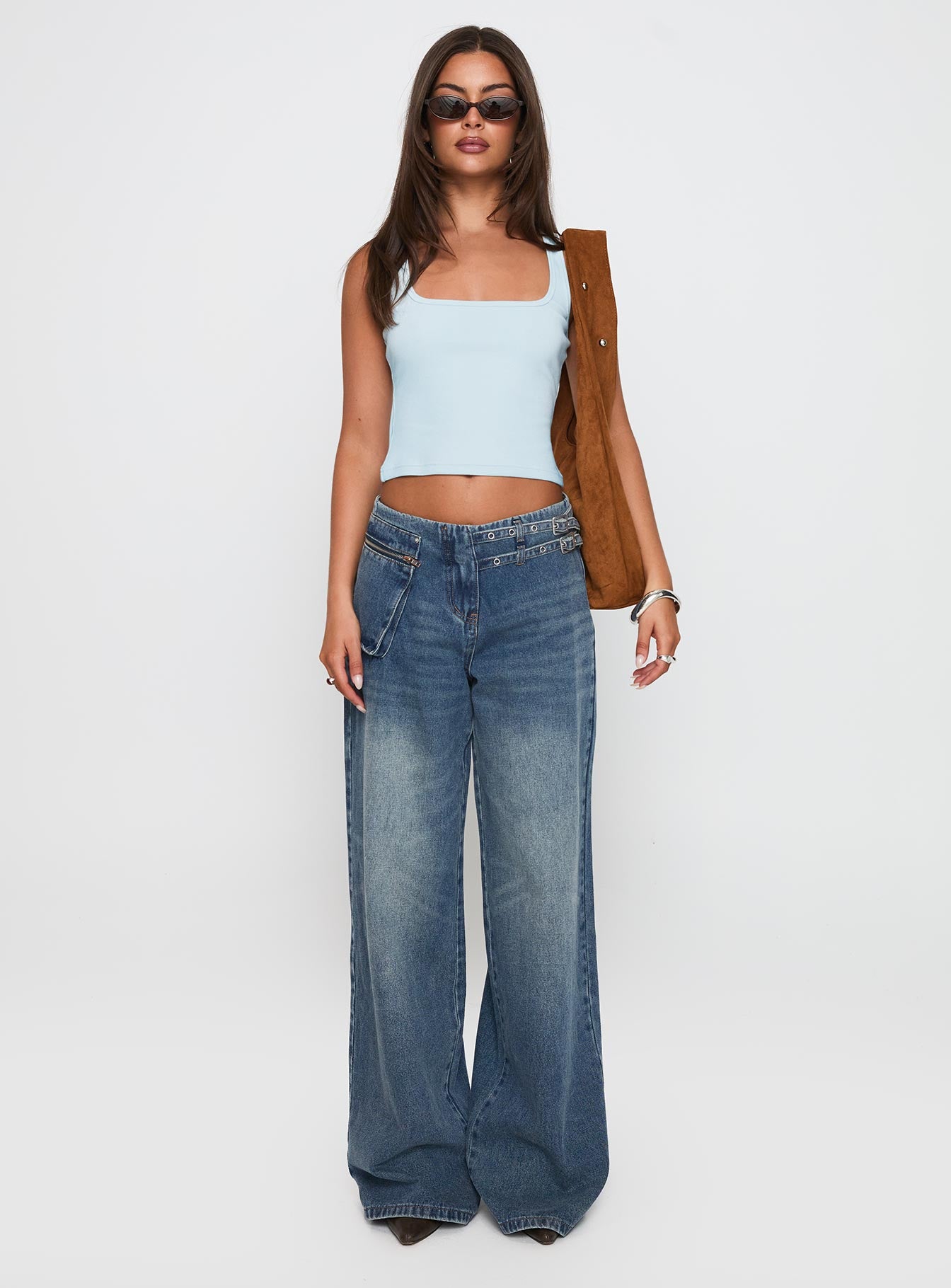 side view of model wearing Princess Polly Paltrow Cargo Jeans Mid Blue Wash Mid Rise 