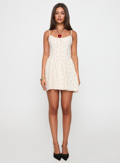 side view of model wearing Princess Polly Toulouse Mini Dress Cream / Floral Scoop Neck 