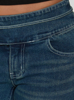 Crafted from Runa Low Rise Tie Side Jeans Mid Blue Wash featuring womens-jeans with flared wide-leg silhouette Princess Polly