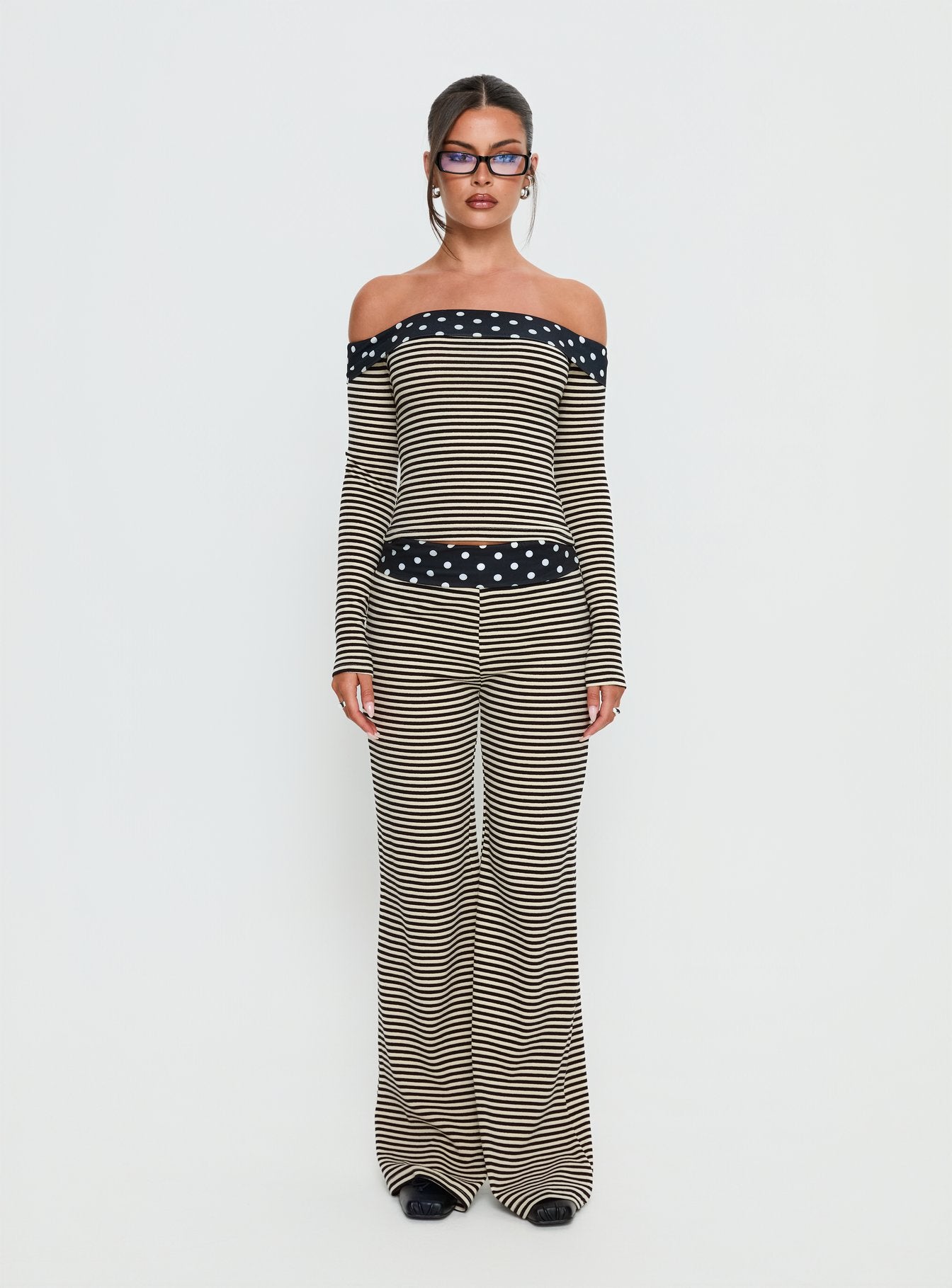 side view of model wearing Princess Polly Virenna Fold Over Pants Black Multi Mid Rise Pants 