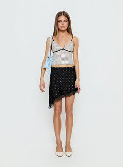   side view of model wearing Princess Polly Idette Lace Asymmetrical Mini Skirt Black Polka Dot Mini Skirts 