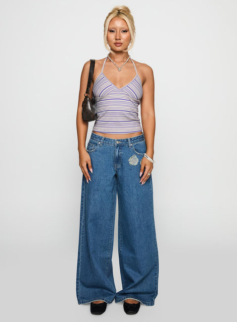 side view of model wearing Princess Polly A Keeper Flower Patch Jeans Mid Blue Low Rise Jeans 