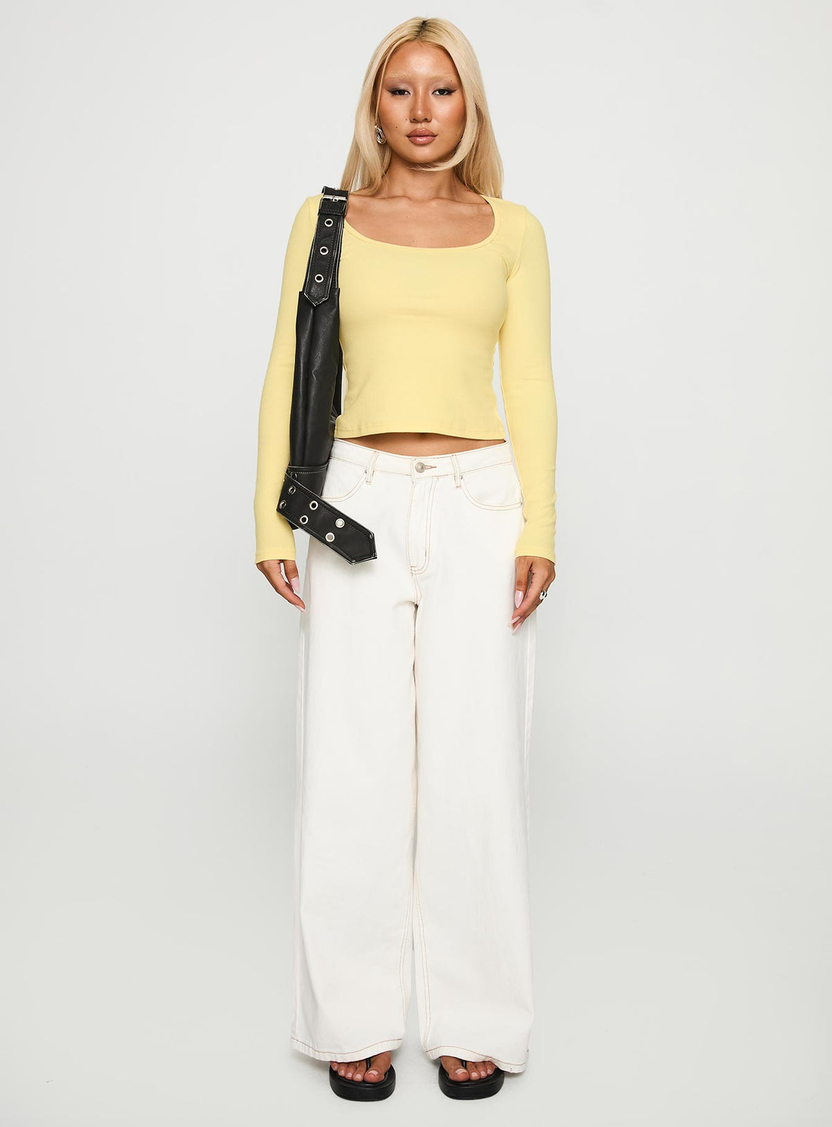 side view of model wearing Princess Polly Baseline Long Sleeve Top Yellow Full Sleeves Scoop Neck 
