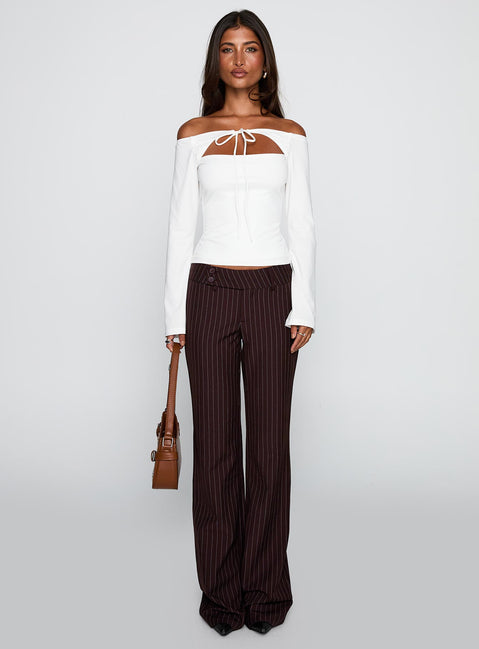 front view of model wearing Princess Polly Kinkirk Flared Pants Brown Pinstripe Low Rise Pants 
