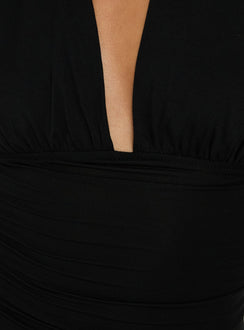 Showcasing the Celinna Multi Wear Bodysuit in sleeveless black with plunge halter neckline and ruched details product view of model wearing
