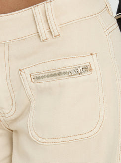side view of model wearing Princess Polly Lifetimes Mid Rise Wide Leg Cargo Jeans Cream Mid Rise Jeans Jeans 