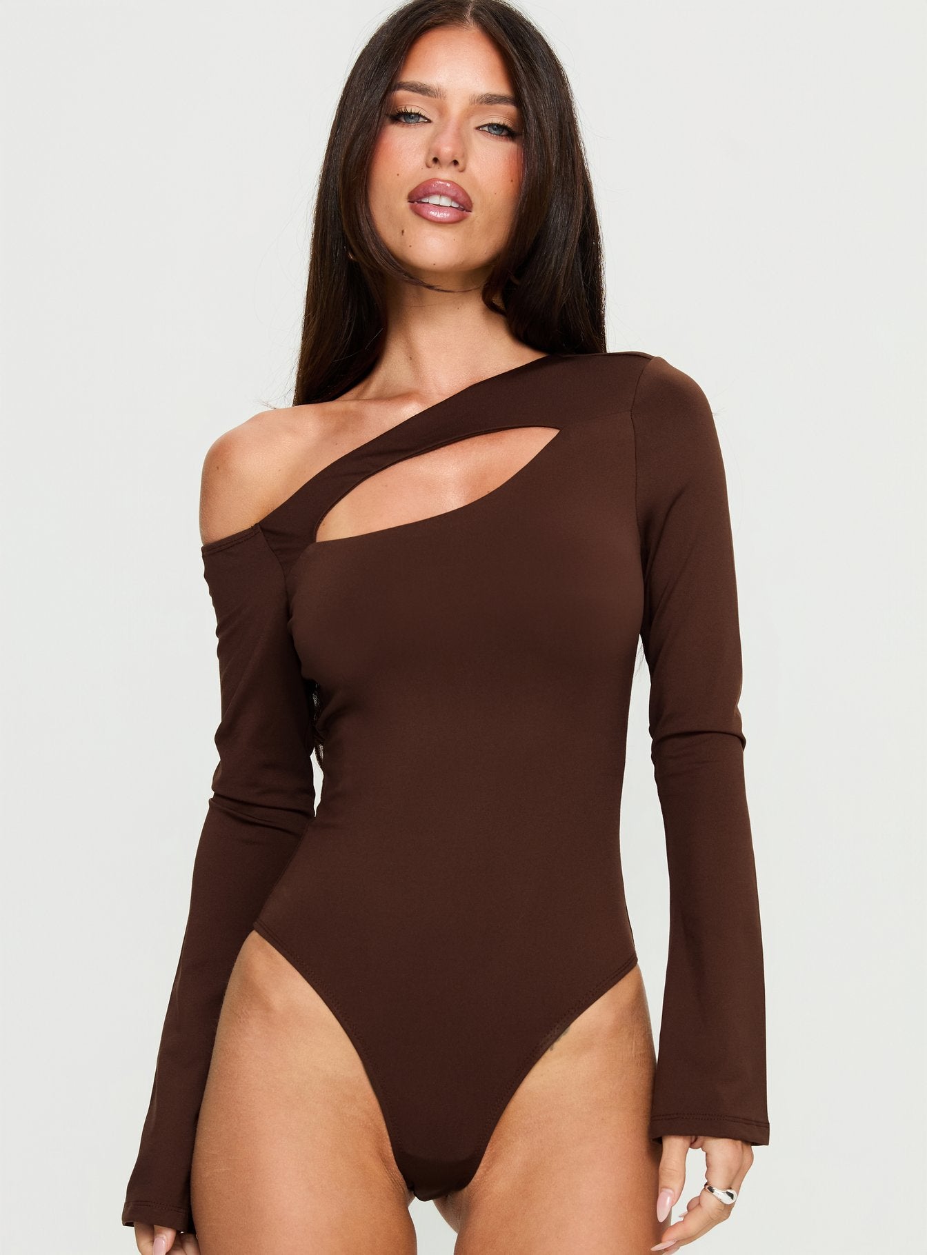 front view of model wearing Princess Polly Raissa Cut Out One Shoulder Bodysuit Brown Long Sleeve Tops 