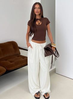 Showcasing the Peacemaker Tie Waist Relaxed Pants Off-White in womens regular pants featuring mid-rise styling front view of model wearing Princess Polly