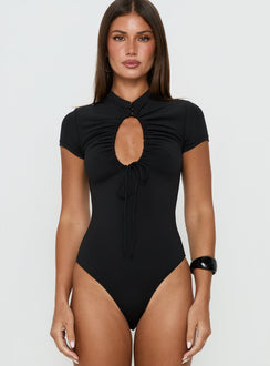 Showcasing the Maeci Ruched Tie Detail Bodysuit Black in womens-bodysuit with short sleeves, high-neck keyhole neckline front view of model wearing Princess Polly