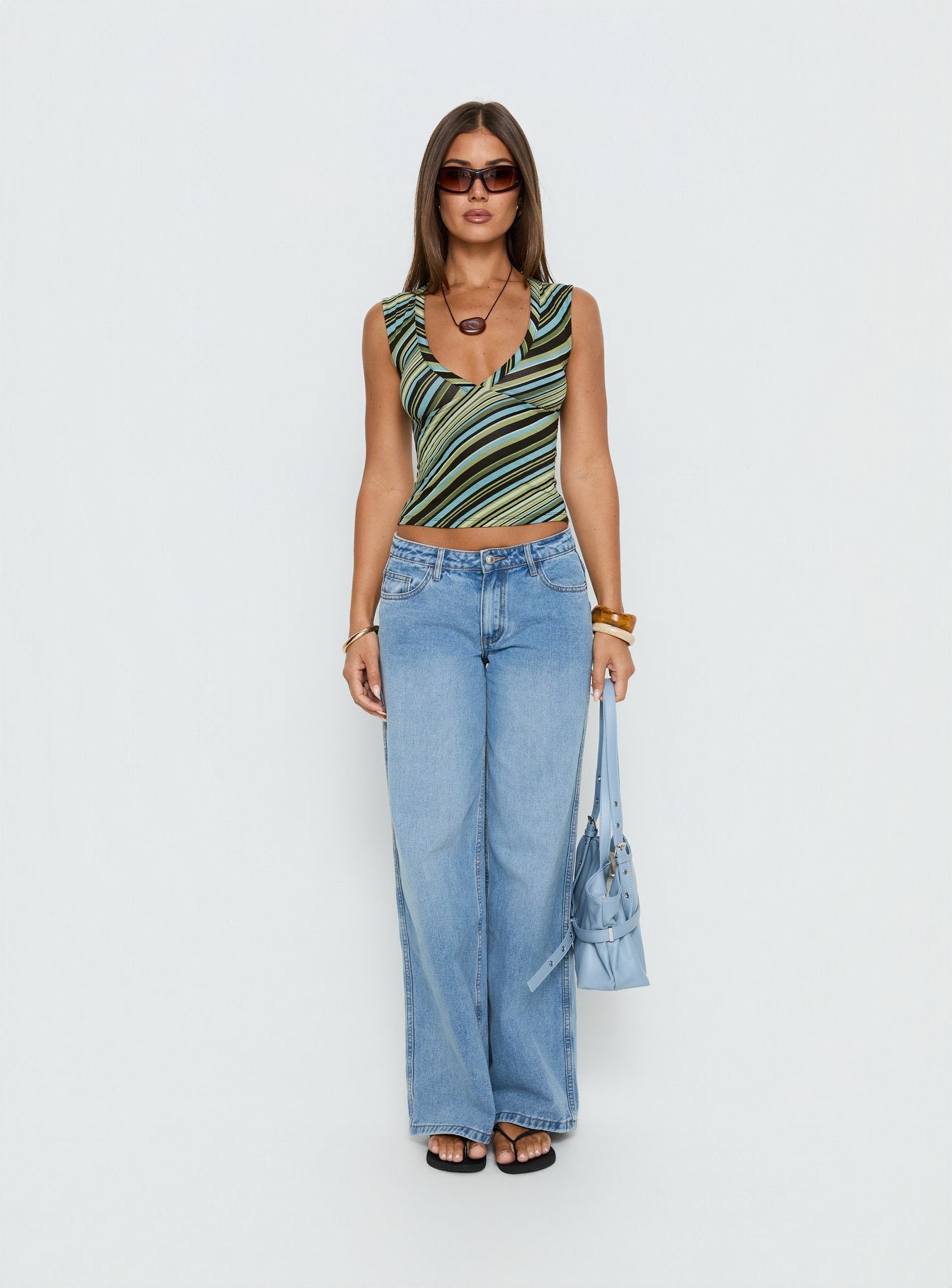 front view of model wearing Princess Polly Ramos Low Rise Wide Leg Denim Jeans Bright Blue Wash Mid Rise Jeans Jeans 
