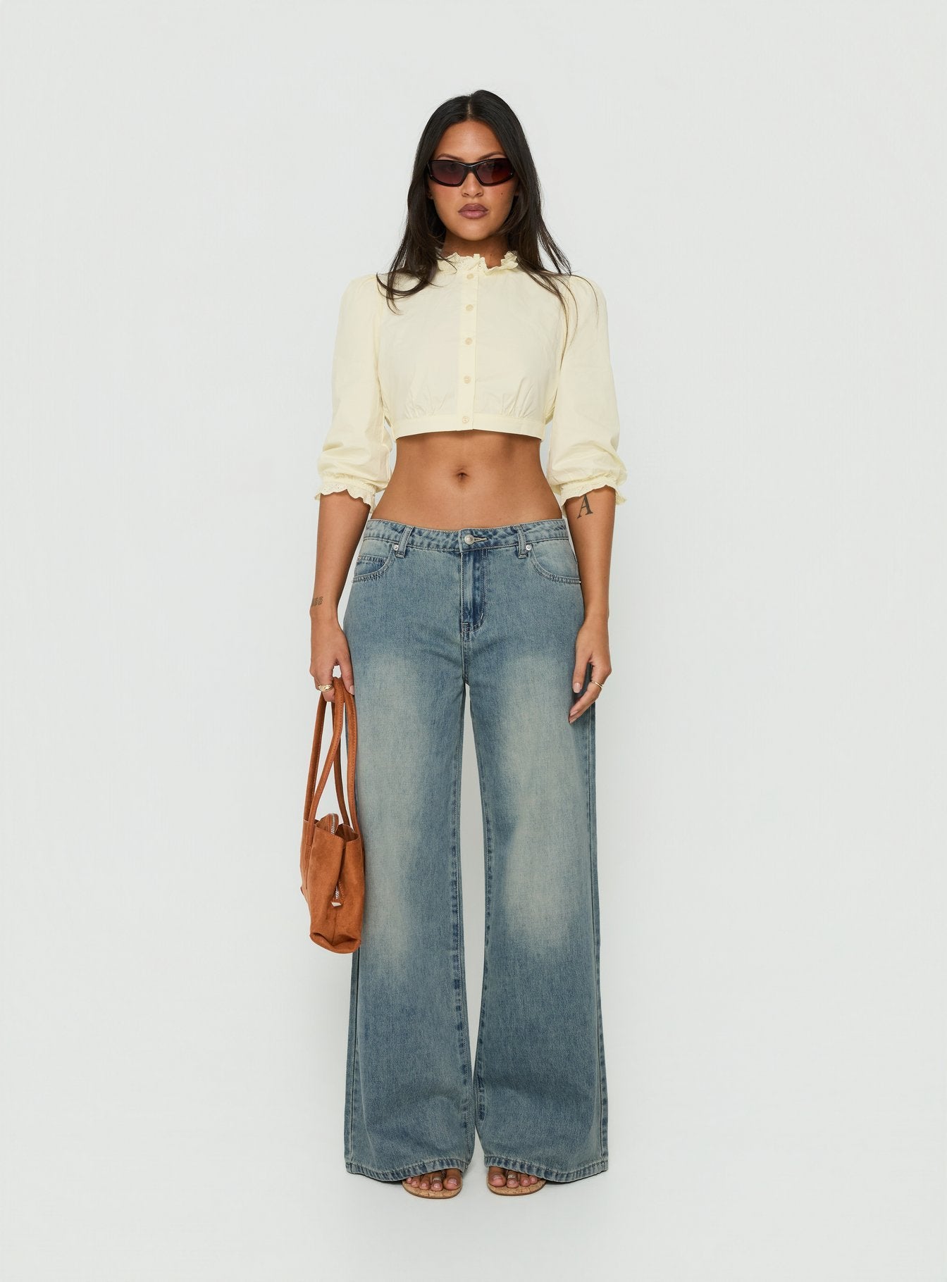 Featuring Karlos Low Rise Cinched Baggy Jeans Vintage Mid Blue Wash womens-jeans in low-rise front view of model wearing Princess Polly