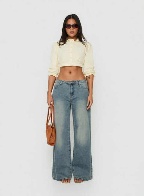 Featuring Karlos Low Rise Cinched Baggy Jeans Vintage Mid Blue Wash womens-jeans in low-rise front view of model wearing Princess Polly