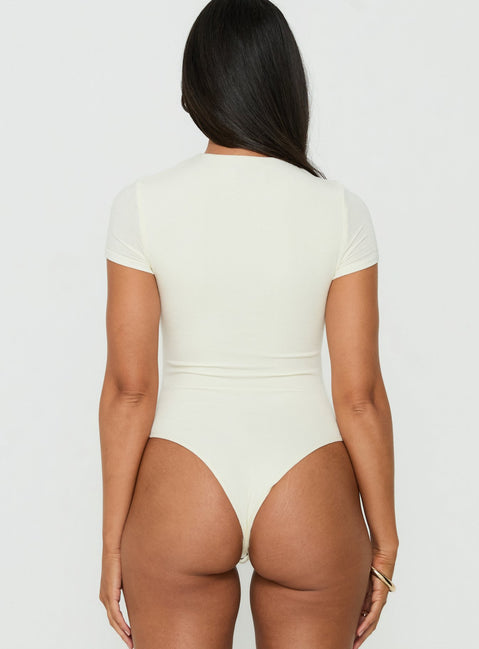 Designed with v-neck the Odettea Cross Front Short Sleeve Bodysuit in Cream womens-bodysuit and short sleeves back view of model wearing Princess Polly