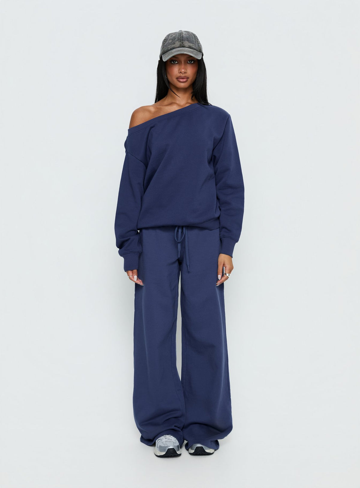 side view of model wearing Princess Polly Wellness Off the Shoulder Jumper Navy 