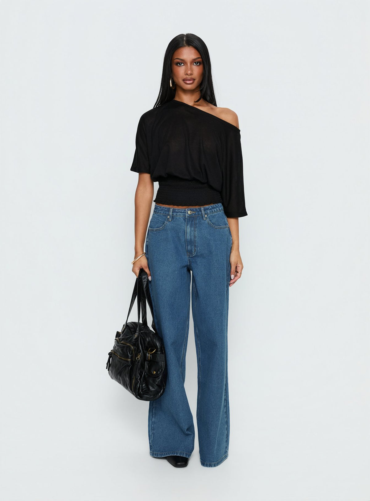 side view of model wearing Princess Polly Naylor Mid Rise Wide Leg Jeans Mid Blue Wash Mid Rise Jeans 