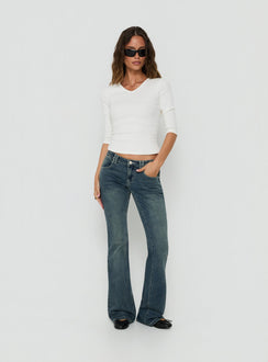 Showcasing the Clynee Ultra Low Rise Bootleg Jeans Dirty Blue in womens-jeans with low-rise waist front view of model wearing Princess Polly