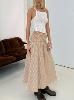 Showcasing the Vence Ruched Maxi Skirt Brown Gingham in womens-skirts with checkered print and relaxed a-line shape front view of model wearing Princess Polly
