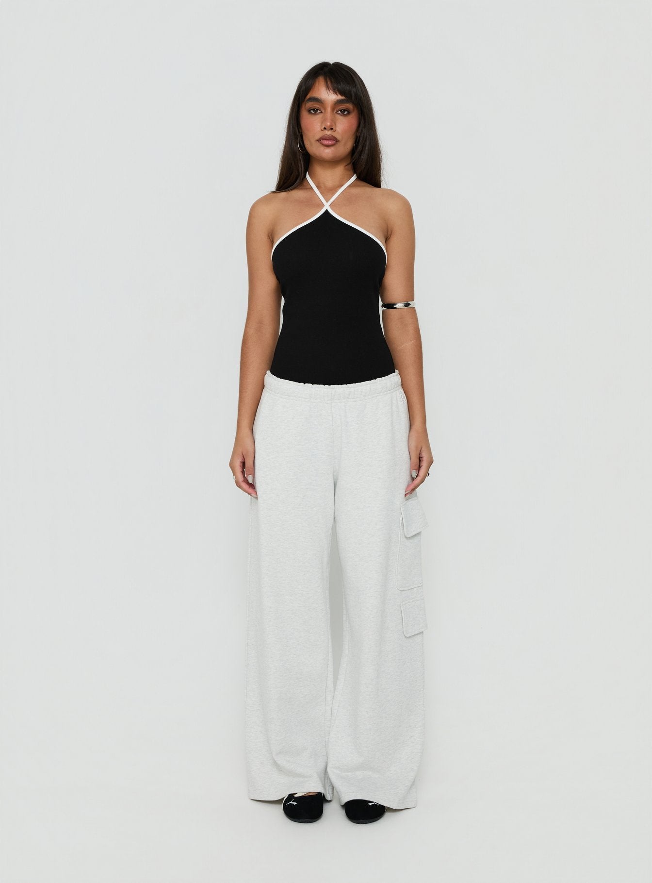 Showcasing the Azara Contrast Arrowneck Bodysuit Black / White womens-bodysuit with sleeveless design front view of model wearing Princess Polly