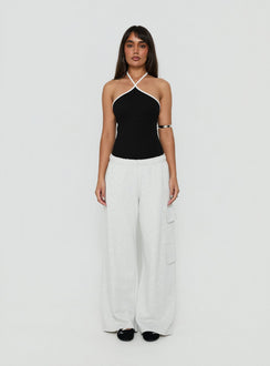 Showcasing the Azara Contrast Arrowneck Bodysuit Black / White womens-bodysuit with sleeveless design front view of model wearing Princess Polly