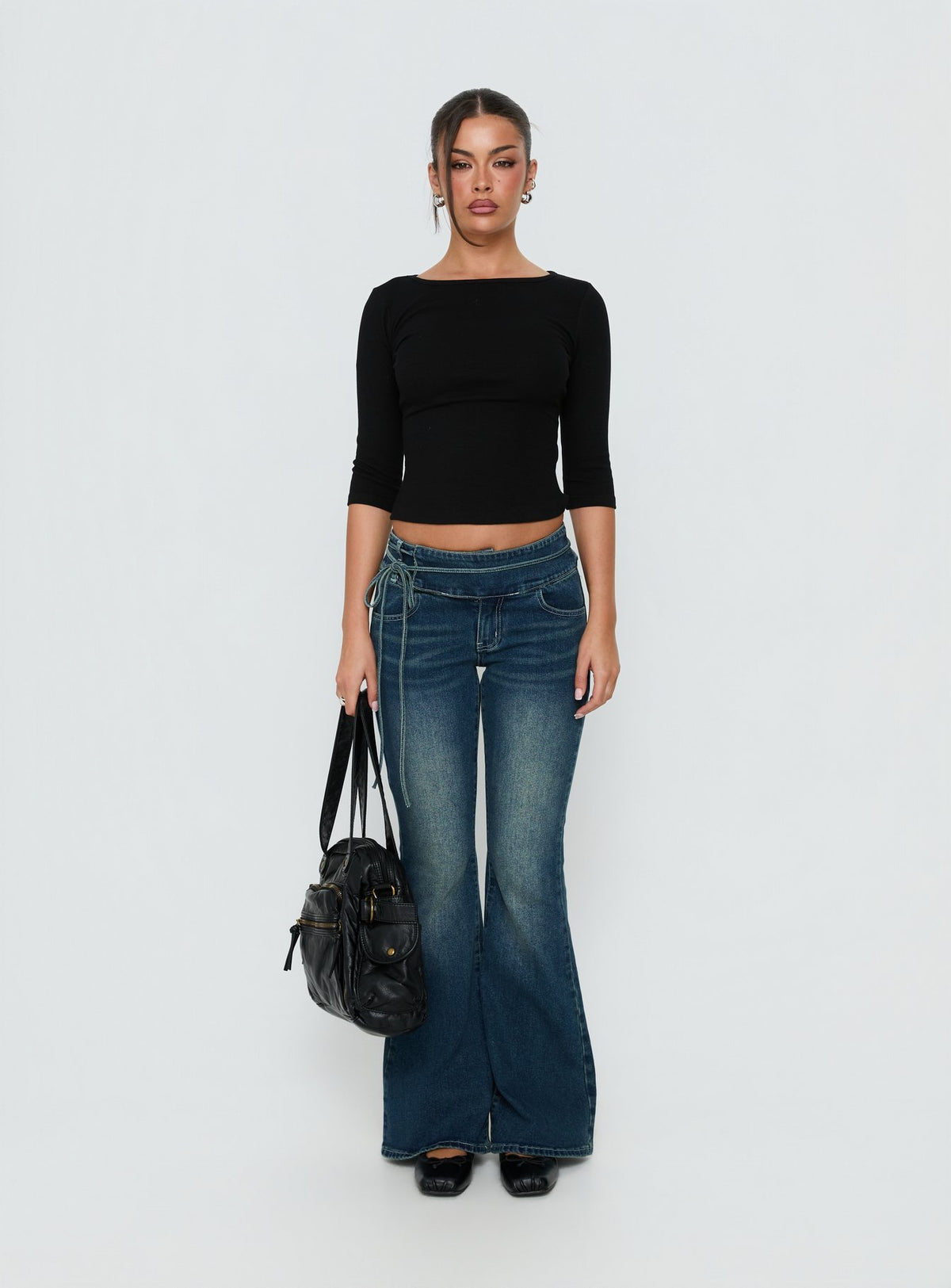 Showcasing Runa Low Rise Tie Side Jeans Mid Blue Wash in womens-jeans front view of model wearing Princess Polly