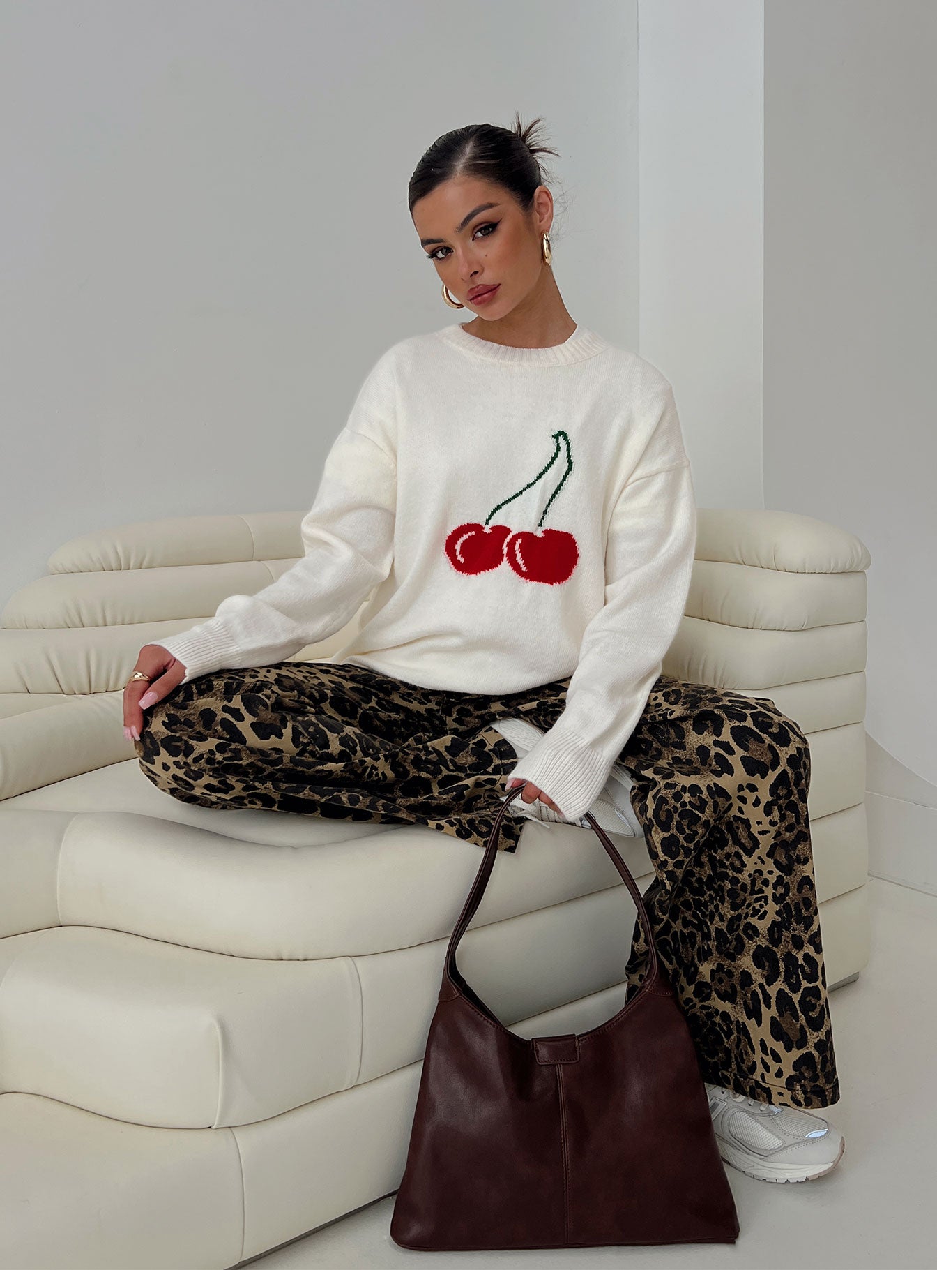 Showcasing the Cherry Dreams Knit Jumper Cream womens jumpers with long styling on-body view of model wearing Princess Polly