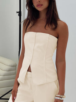 side view of model wearing Princess Polly Lavish Living Strapless Top Cream Sleeveless straight 
